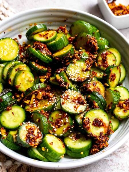 Spicy Asian cucumber salad, Easy Asian cucumber salad recipe, Chili oil cucumber salad, Refreshing cucumber salad with Asian flavors, Low-calorie spicy cucumber salad